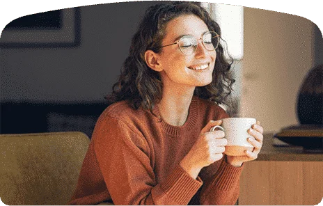woman holding a cup while smiling