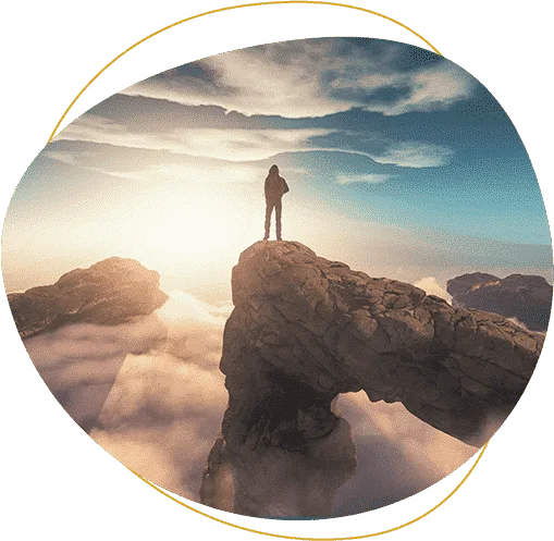 person on top of a hill with clouds below